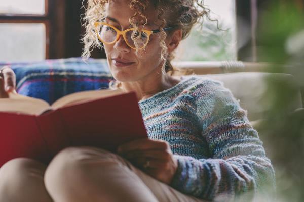 bigstock Woman At Home Sitting And Read 467714967
