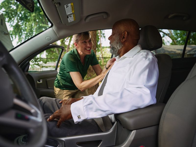 home instead caregiver and senior client in car