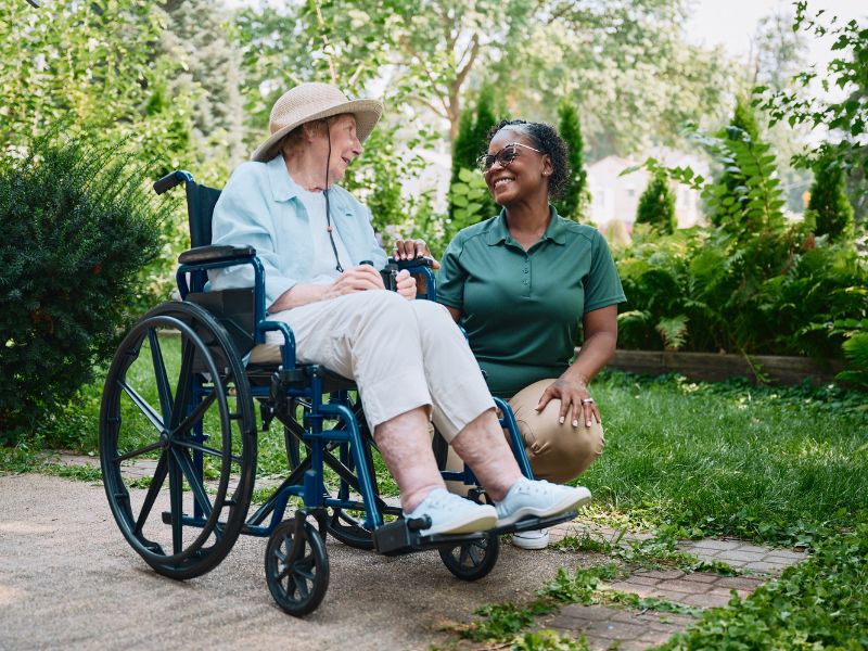 Home Instead caregiver assisting a senior in a wheel chair