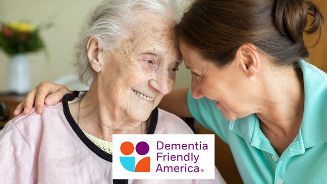 older woman and younger woman embracing and smiling at each other