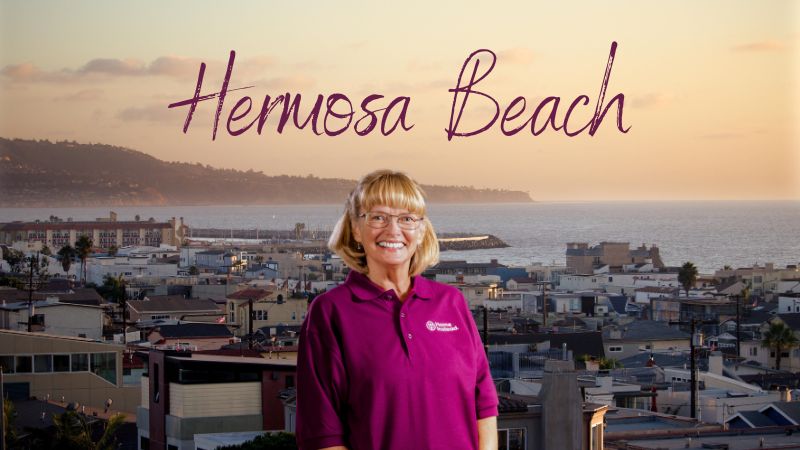 Home Instead caregiver with Hermosa Beach California in the background