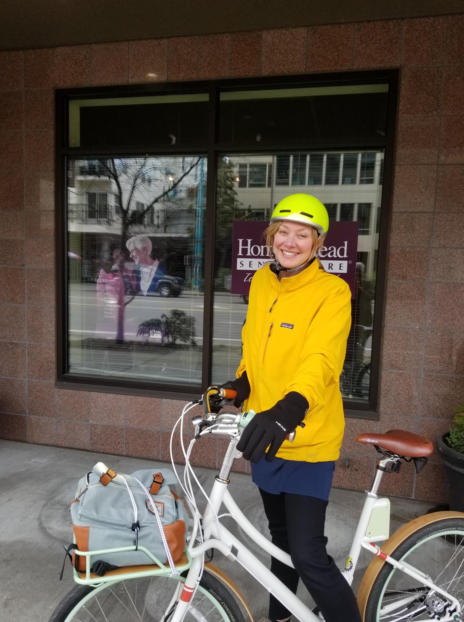 Home Instead Team Member on her bike outside of the Home Instead office